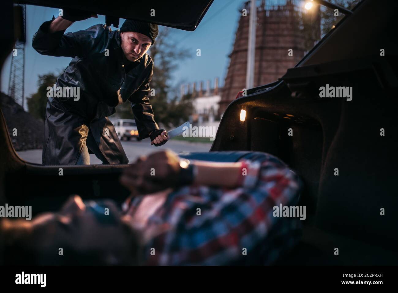 Serial maniac looks on female victim in car trunk, mouth and hands