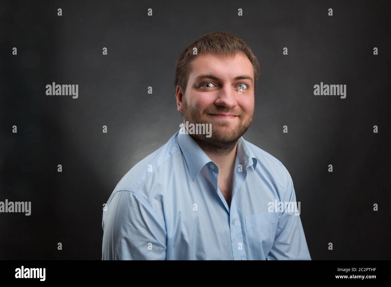 Man in blue shirt wearing hi-res stock photography and images - Alamy