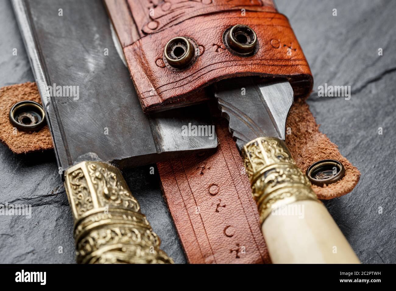 Details of a traditional handmade balinese knife belakas shot on a slate background. Bali