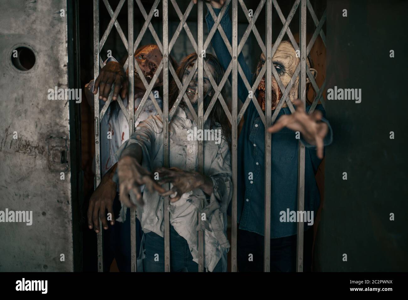 Zombie hands sticking out of the elevator, deadly chase. Horror in city, creepy crawlies attack, doomsday apocalypse, bloody monsters Stock Photo