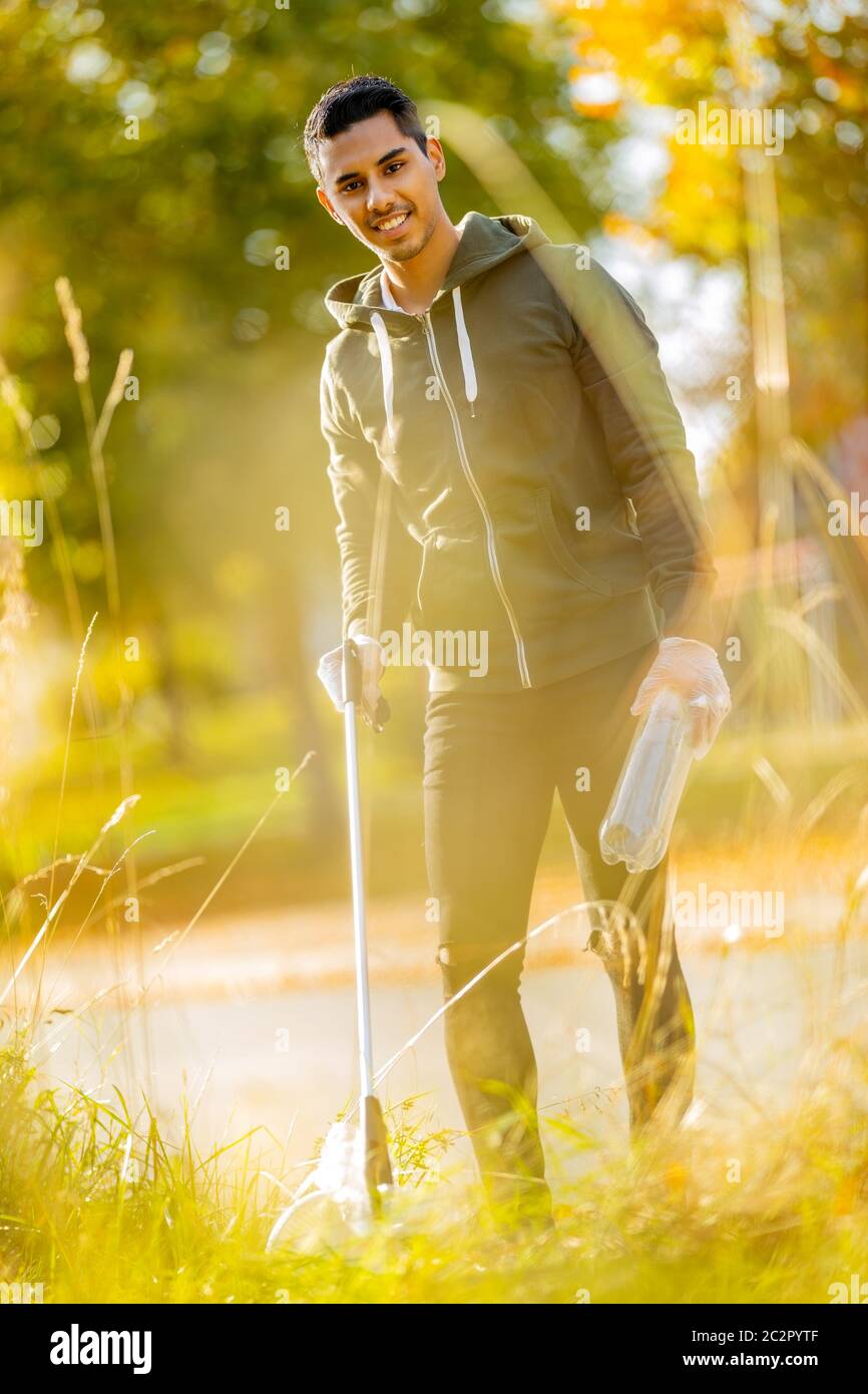 Smiling volunteer conserving environment from pollution and plastic Stock Photo
