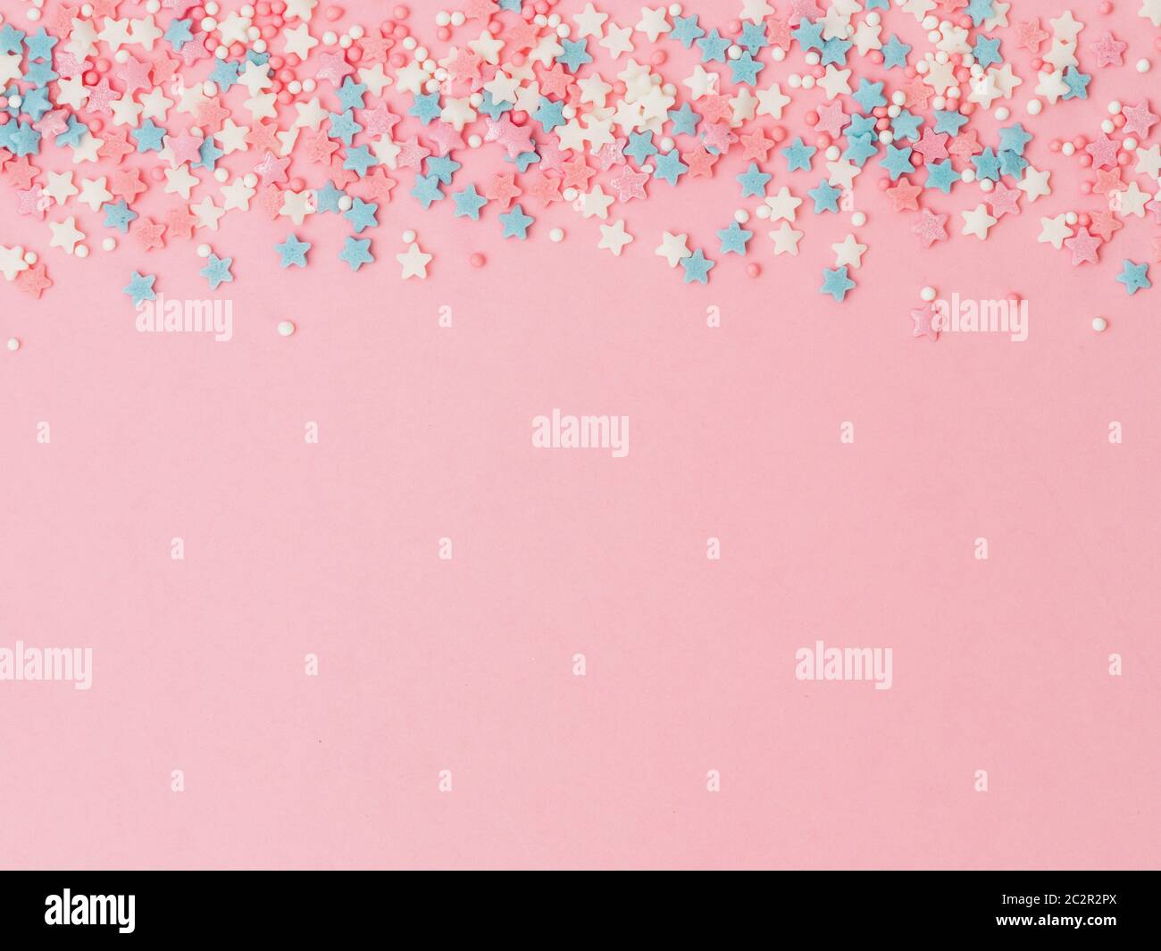 Festive border frame of colorful pastel sprinkles on pink background, copy  space top. Sugar sprinkle dots and stars, decoration for cake and bakery. T  Stock Photo - Alamy