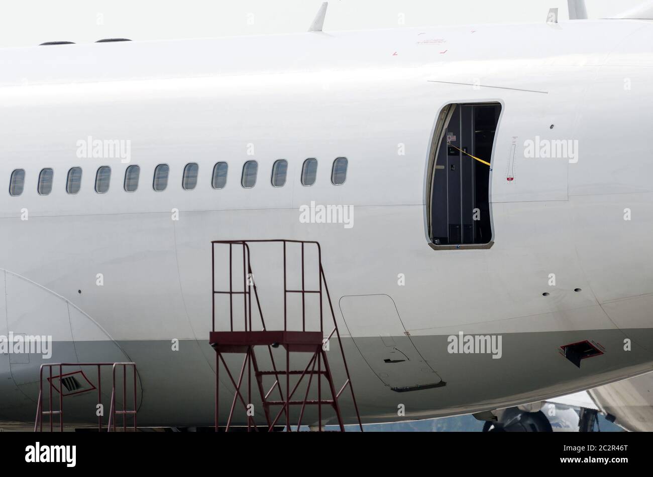 Portholes and an open door to a passenger plane, on service after the flight Stock Photo