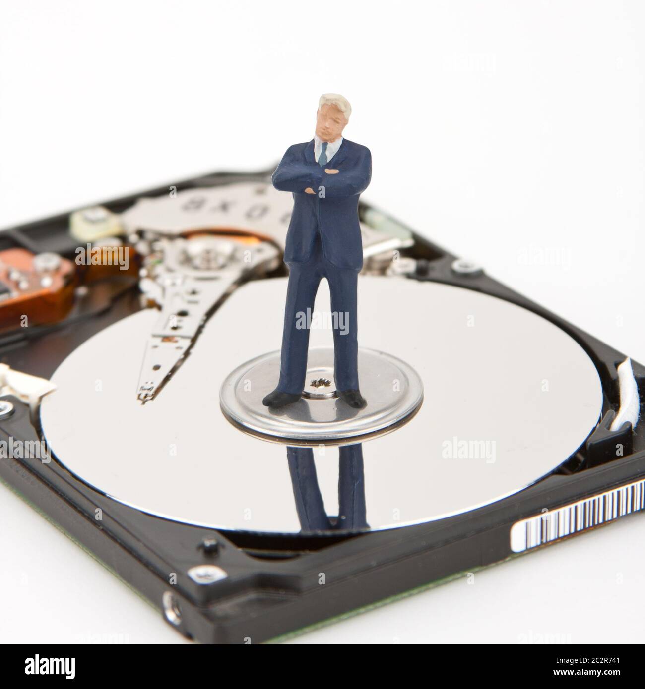 IT security. Businessman on computer hard drive Stock Photo
