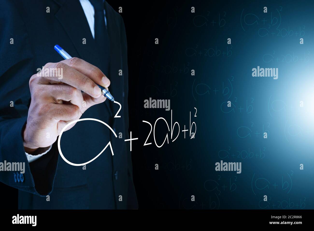 Man writing the mathematical equations Stock Photo