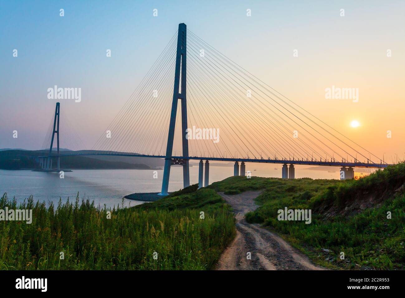 Cable-stayed bridge 'Russky Bridge' to island Russkiy on the sunset. Vladivostok, Primorsky Krai, Russia Stock Photo