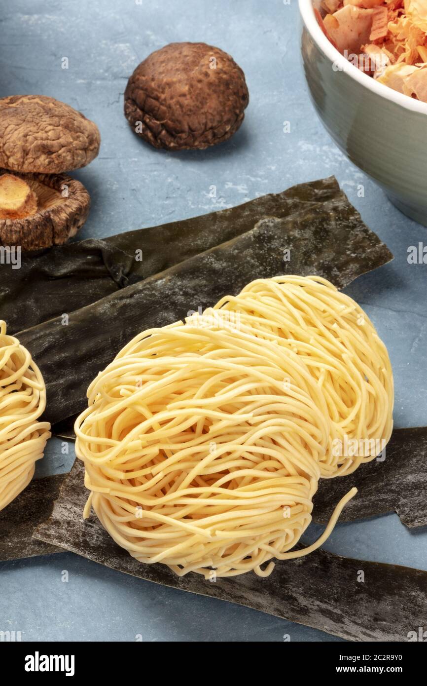 Udon noodles, closeup with dried sea vegetable kelp, shiitake mushrooms, and Katsuobushi tuna