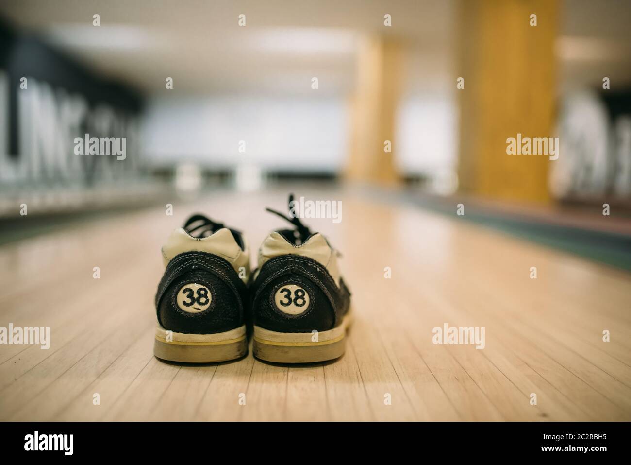 Bowling house shoes on lane in club, closeup view, nobody. Bowl game concept, active hobby Stock Photo