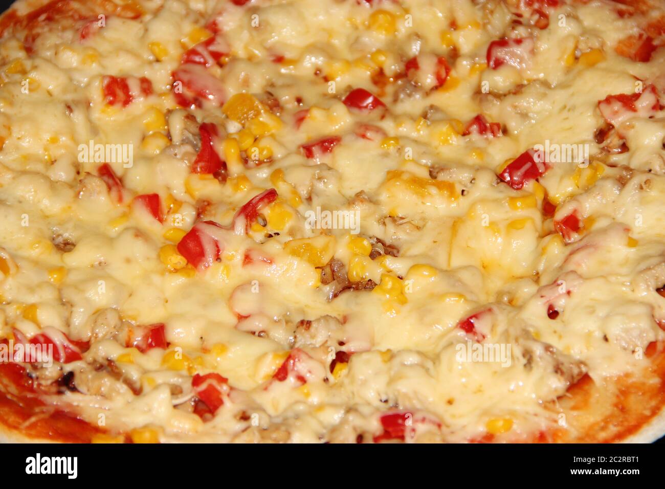 Fresh appetizing pizza with delicious ingredients close up. Tasty pizza on plate close up. Stock Photo