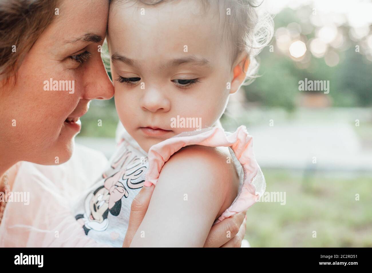 Portrait of a young girl being held by his mother Stock Photo