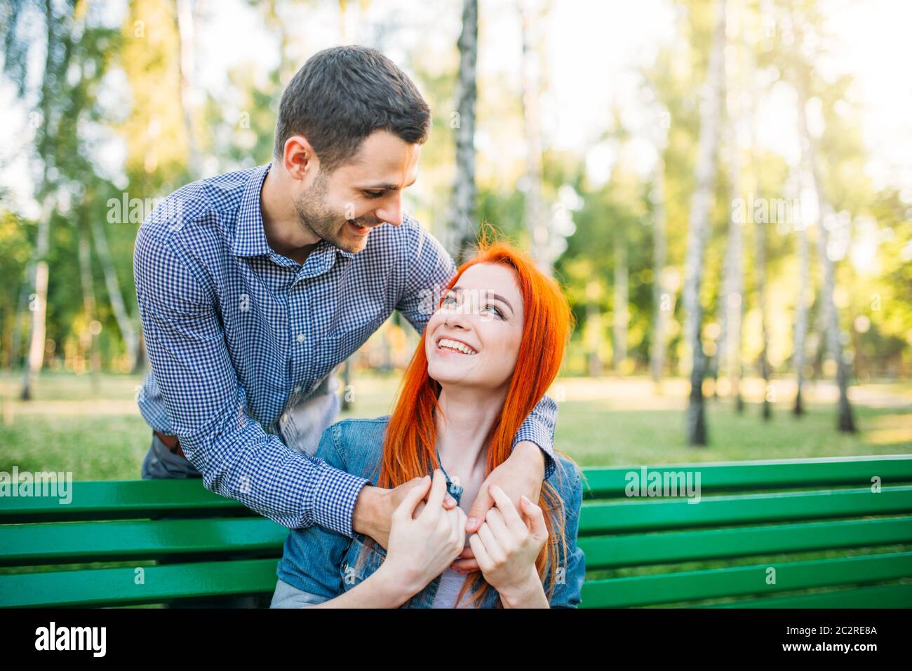 Romantic meeting of love couple in summer park. Man and woman hugs ...