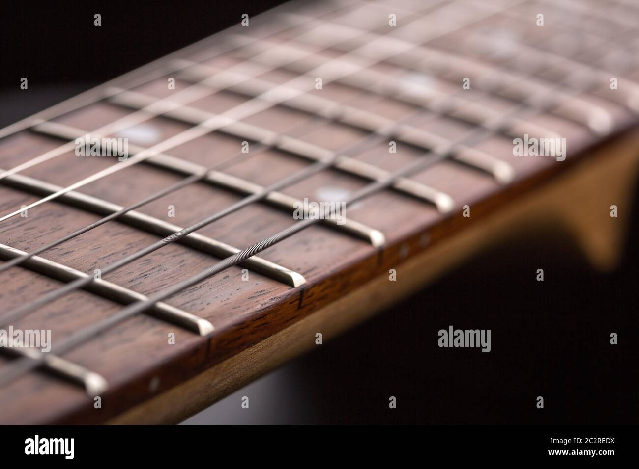 Macro of electric guitar fretboard with strings Stock Photo Alamy