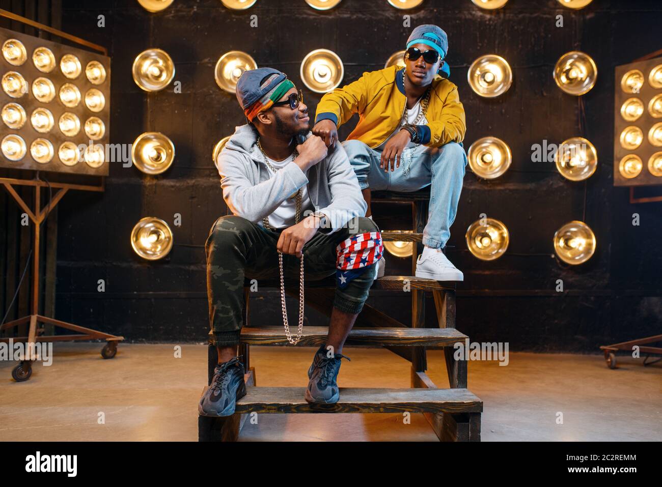 Secene Rappers Two black rappers in sunglasses, perfomance on stage with spotlights on ...