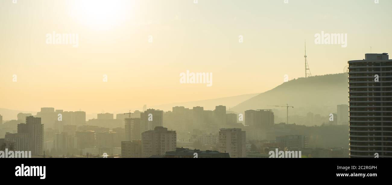 Misty autumnal sunrise over Tbilisi Stock Photo