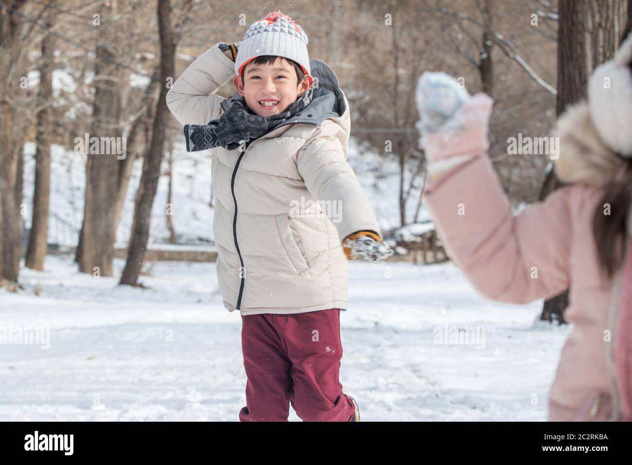 Two children playing in the snow Stock Photo - Alamy