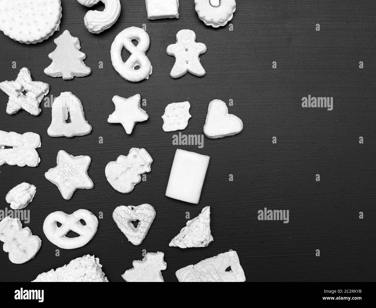 many different white christmas cookies on black background Stock Photo