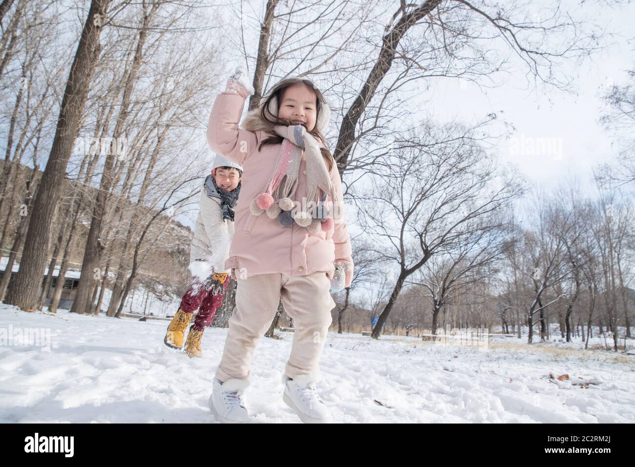 Two children playing in the snow Stock Photo - Alamy