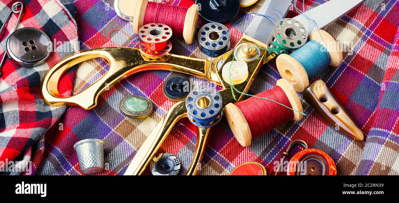 Sewing tools, scissors, buttons and threads on fabric.Sew Stock Photo Alamy