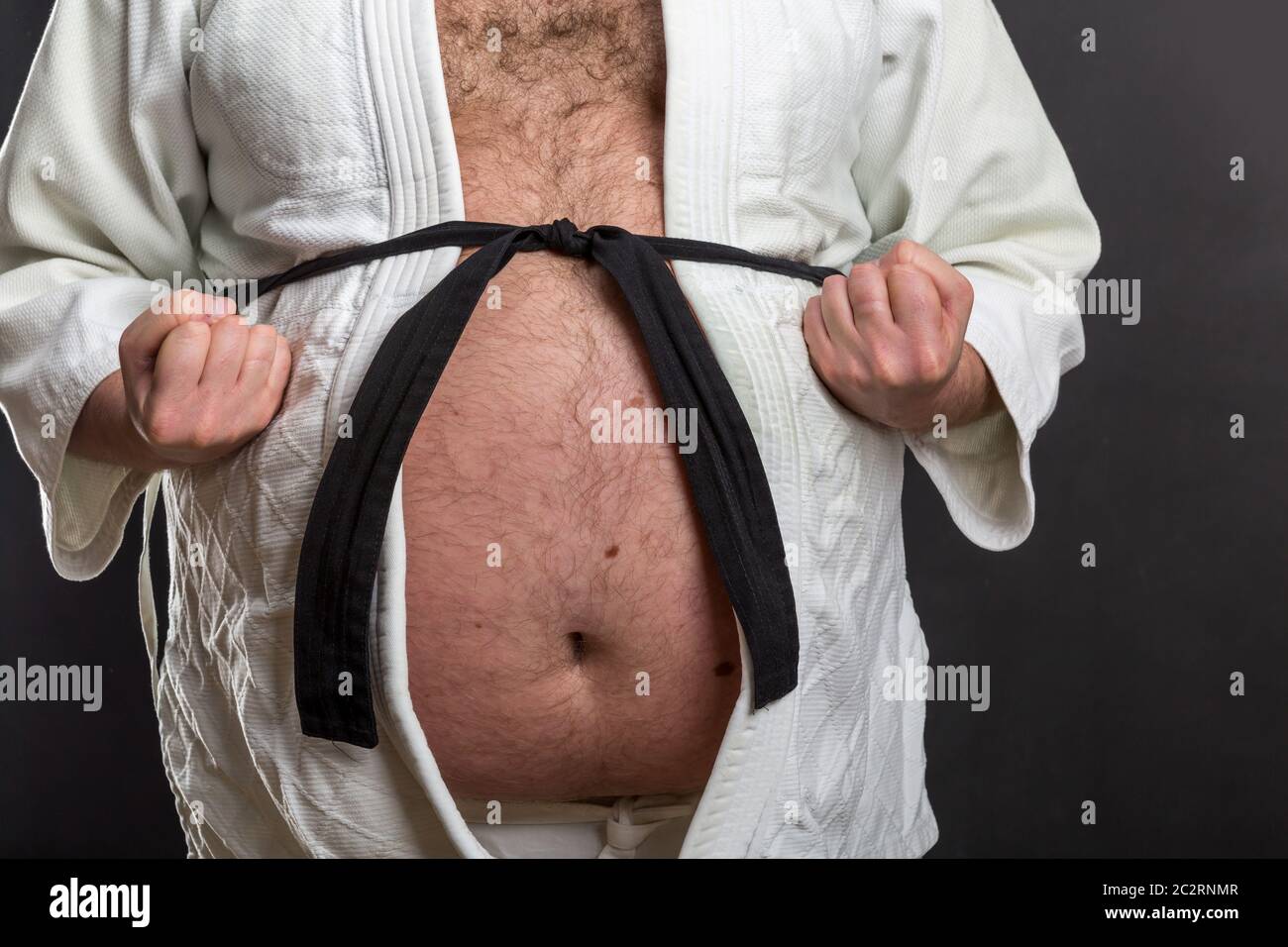 Closeup of fat karate fighter belly in white kimono with black belt Stock  Photo - Alamy