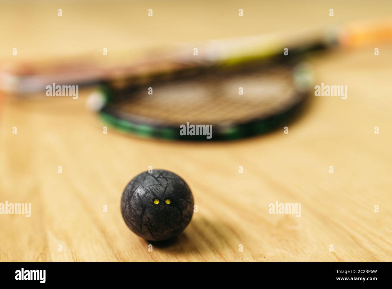 Squash game concept, racket and ball closeup view. Sport equipment on