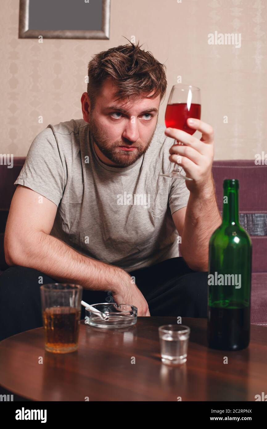 Adult grunge man with glass of alcohol. Drunker in hard drinking Stock