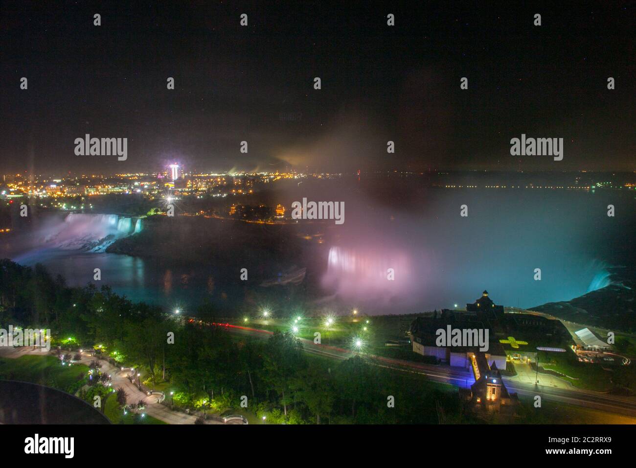 Scenic view from above of Niagara falls at night, with colorful lights on water, Niagara Falls