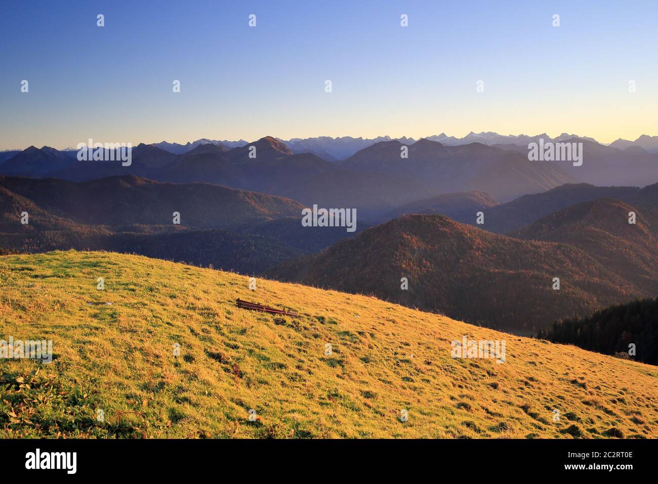 sunny field in the mountains at evening Stock Photo