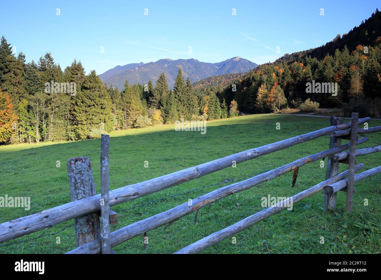 wooden fence on a field in autumn mountain landscape Stock Photo