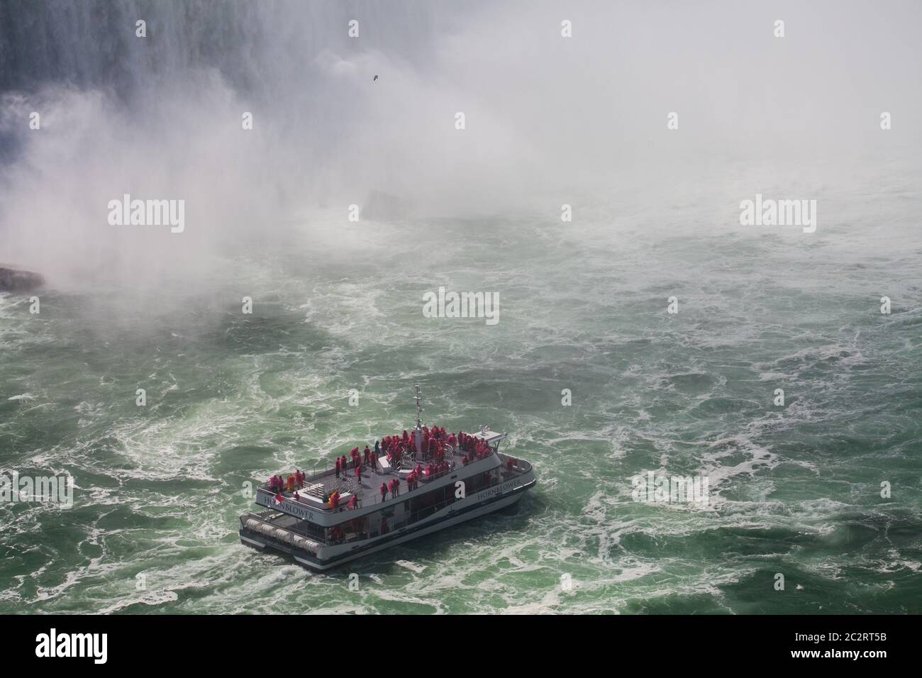 A tourist boat in Niagara river close to Niagara falls, Ontario, Canada Stock Photo