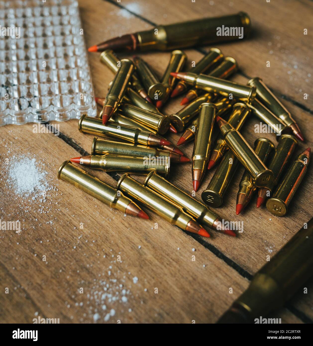 17HMR and .308 Ammunition on board surrounded by powder Stock Photo