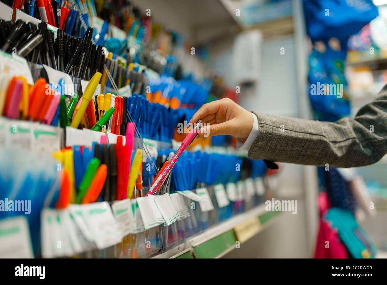 School girl choosing a pen at the shelf in stationery store. Female child  buying office supplies in shop, schoolchild in supermarket Stock Photo -  Alamy