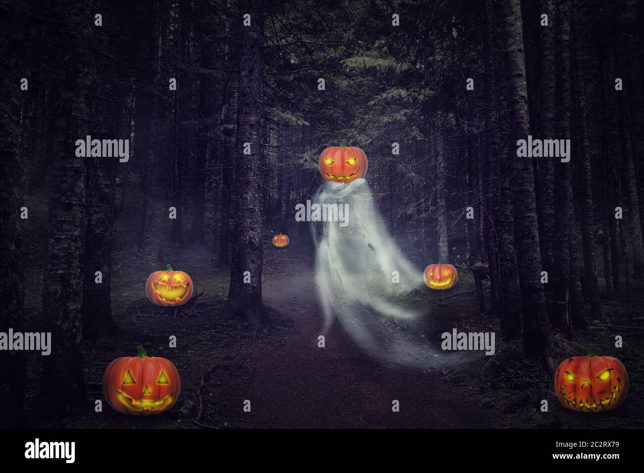 Helloween ghost with pumpkins in the night forest Stock Photo - Alamy