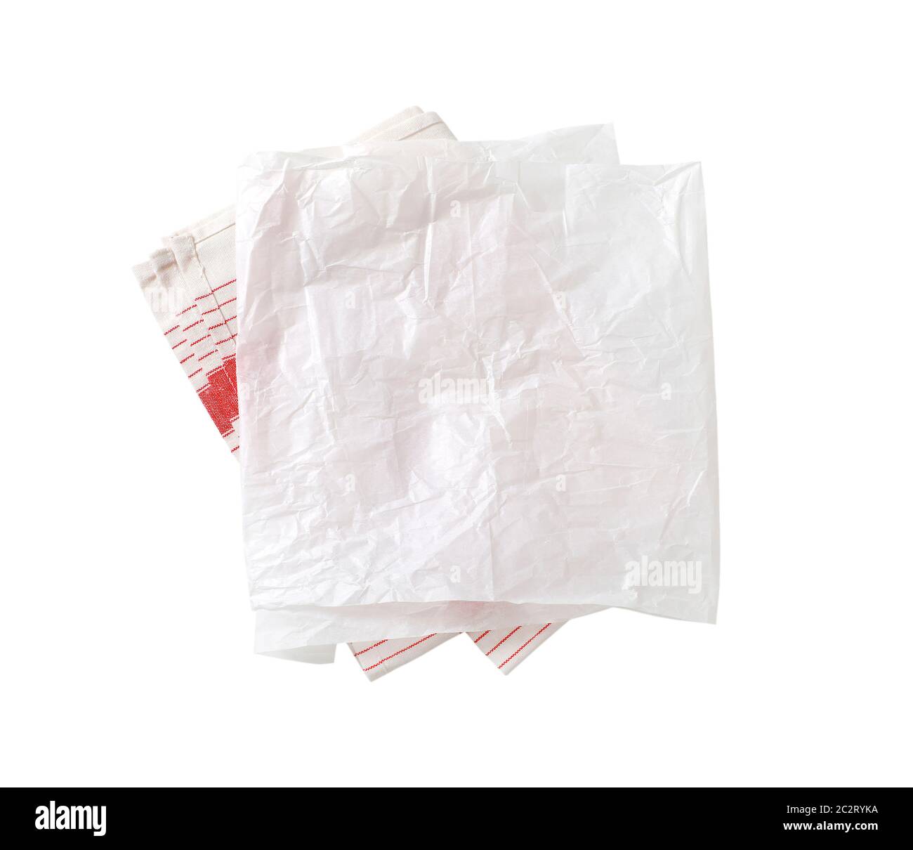 Creased sheet of white wax paper (butcher paper) on tea towel isolated