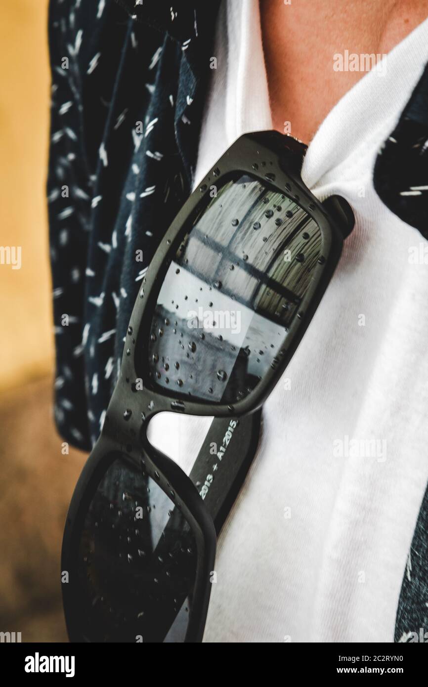 Young teenager wearing modern black glasses with rain drops Stock Photo