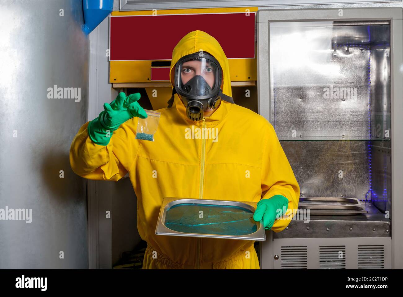 Man in protective outerwear suit sorts crystal meth in packs Stock Photo
