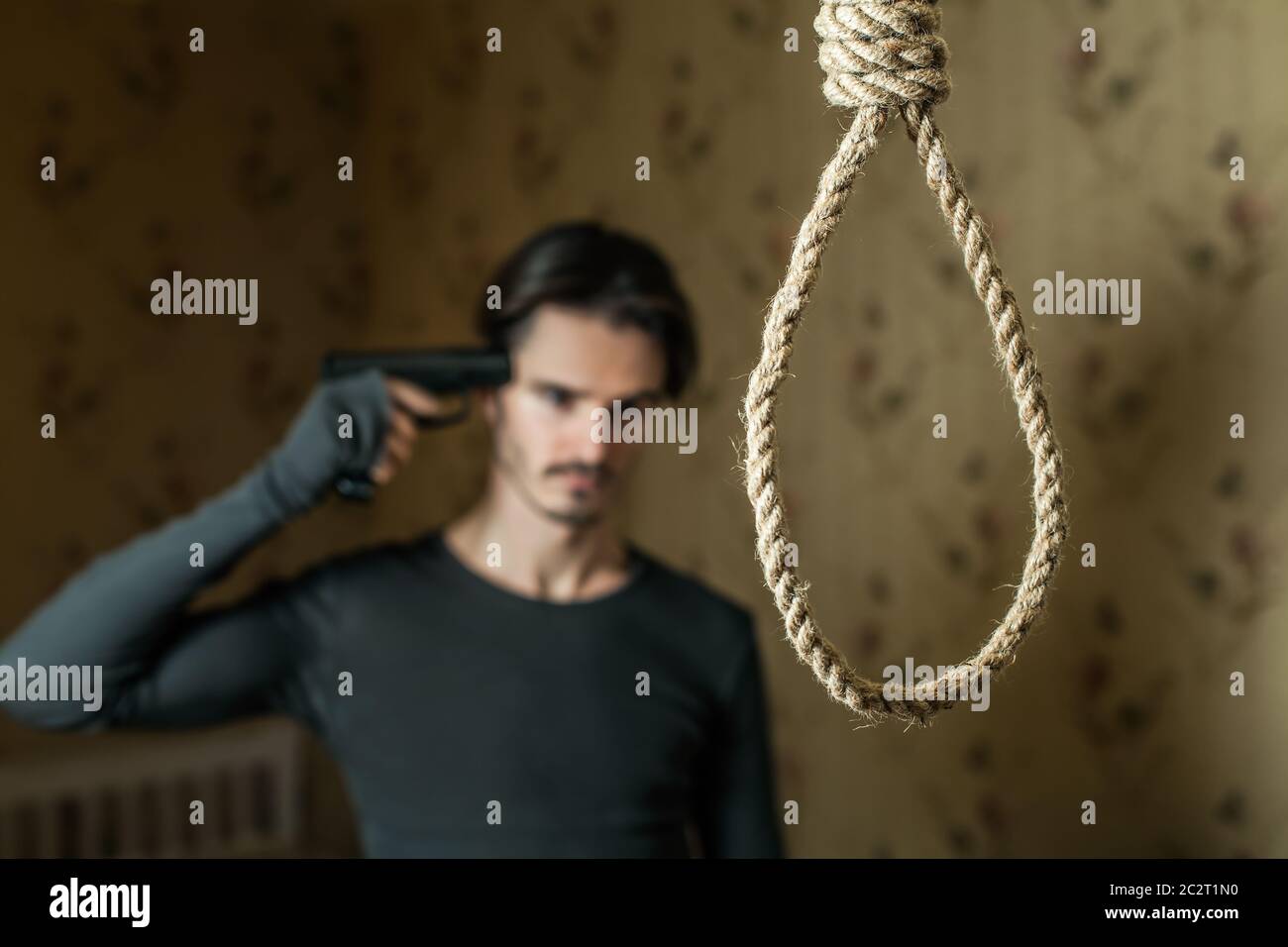Suicide concept, depressed man prepaping to commit suicide with a shot in the head. Stock Photo