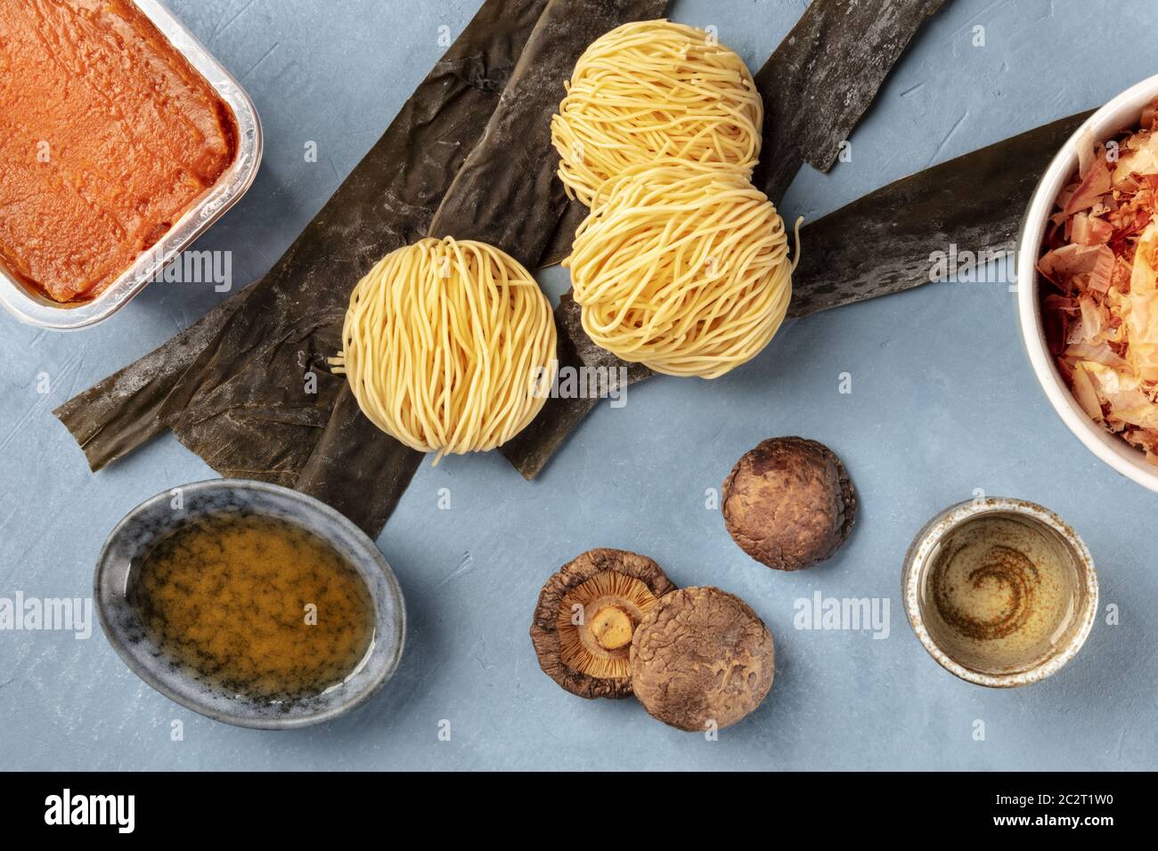 Ramen ingredients. Dried sea vegetable kelp, soba noodles, miso paste, bonito tuna flakes, shiitake mushrooms, sake, mirin, over Stock Photo
