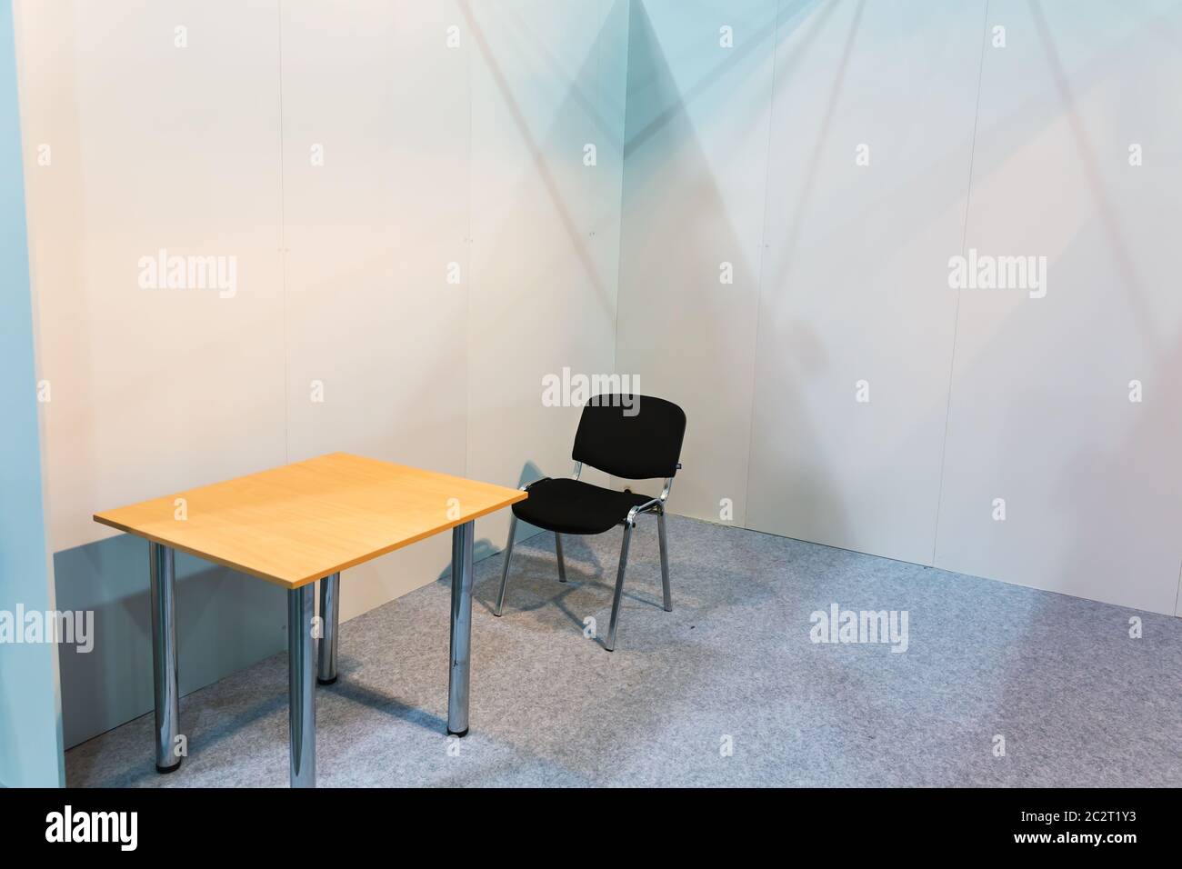 Table and chair in an empty room Stock Photo - Alamy