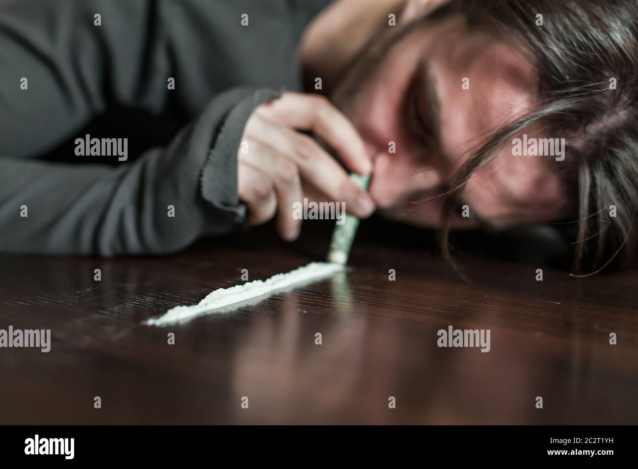Addict in depression smells cocaine trace. Abuse of drugs leads to a
