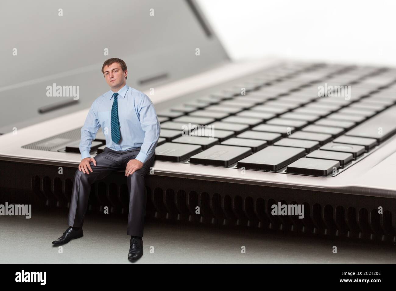 A man sitting on laptop thinks Stock Photo