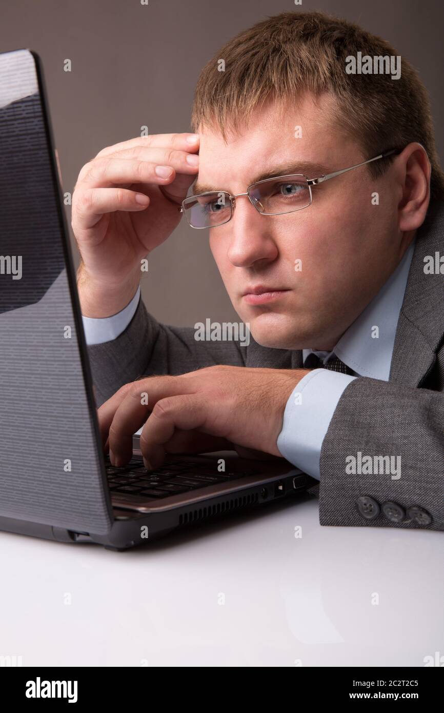 A young office worker working till late Stock Photo Alamy