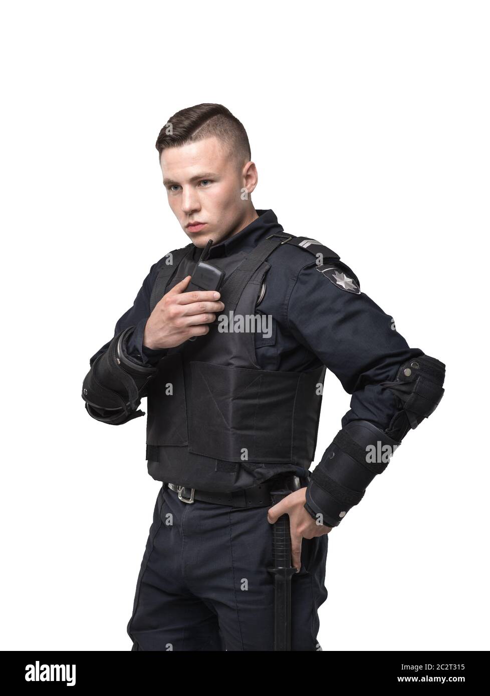 Police officer in black uniform and body armor on white background.  Policeman in special ammunition Stock Photo - Alamy
