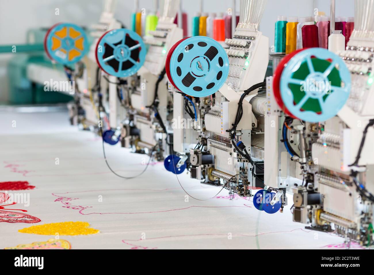 Sewing Factory Background Factory sewing machine makes color pattern closeup. Textile fabric ...