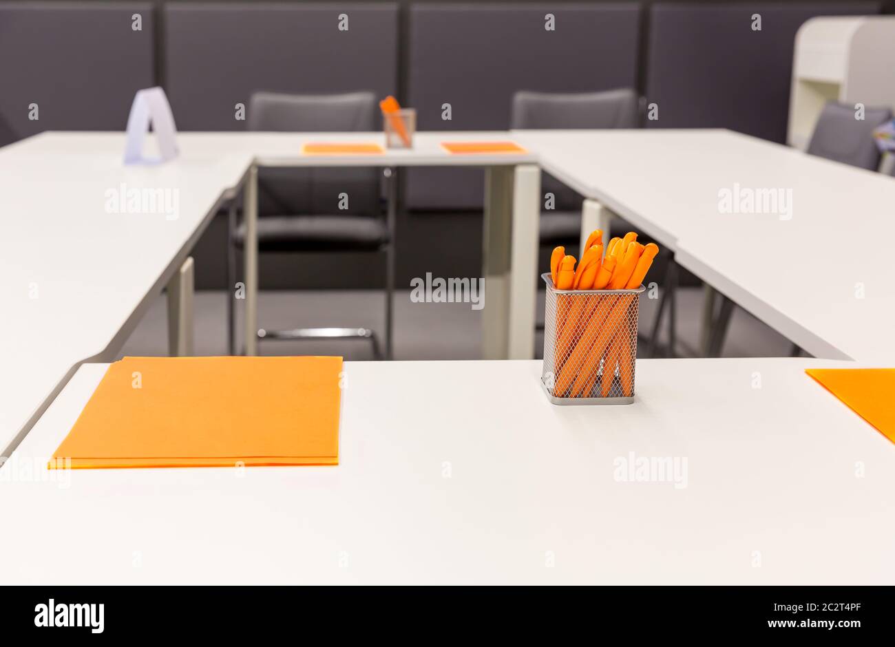 Modern office with orange pens and papers Stock Photo