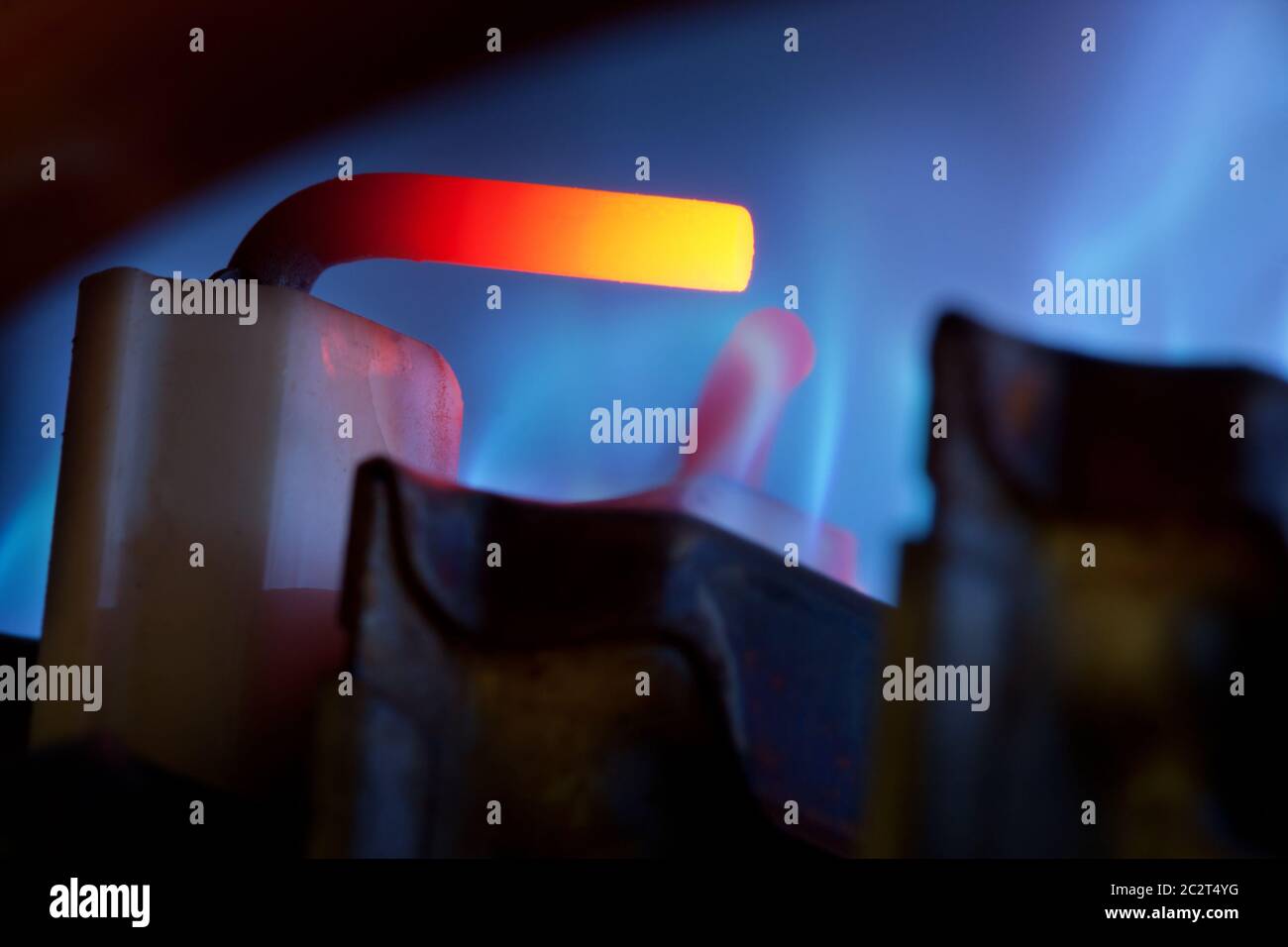 Close-up view of gas control and blue flames in gas boiler Stock Photo