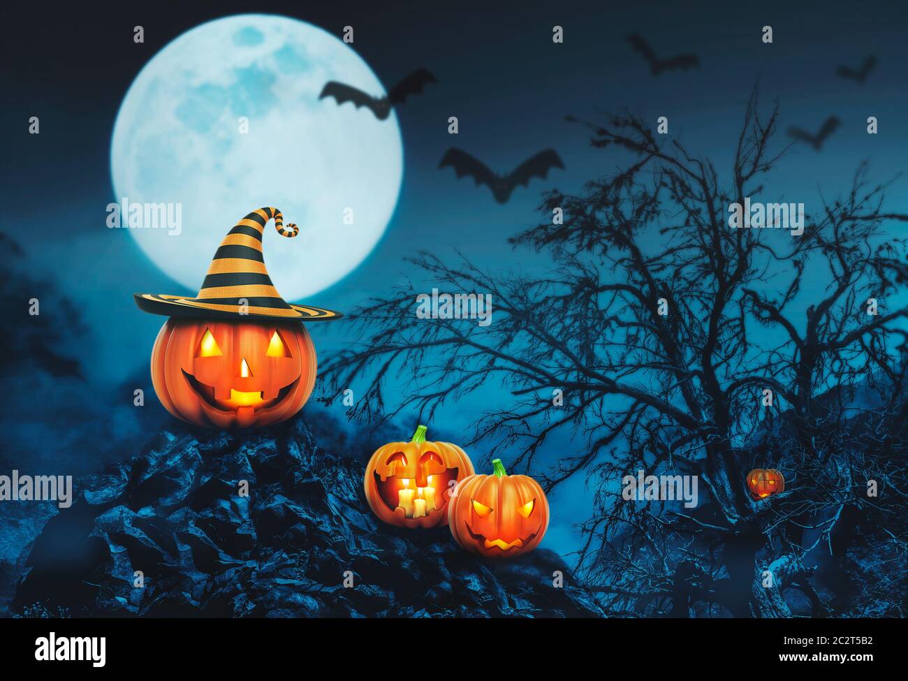 Helloween pumpkins with candles in the night forest Stock Photo - Alamy
