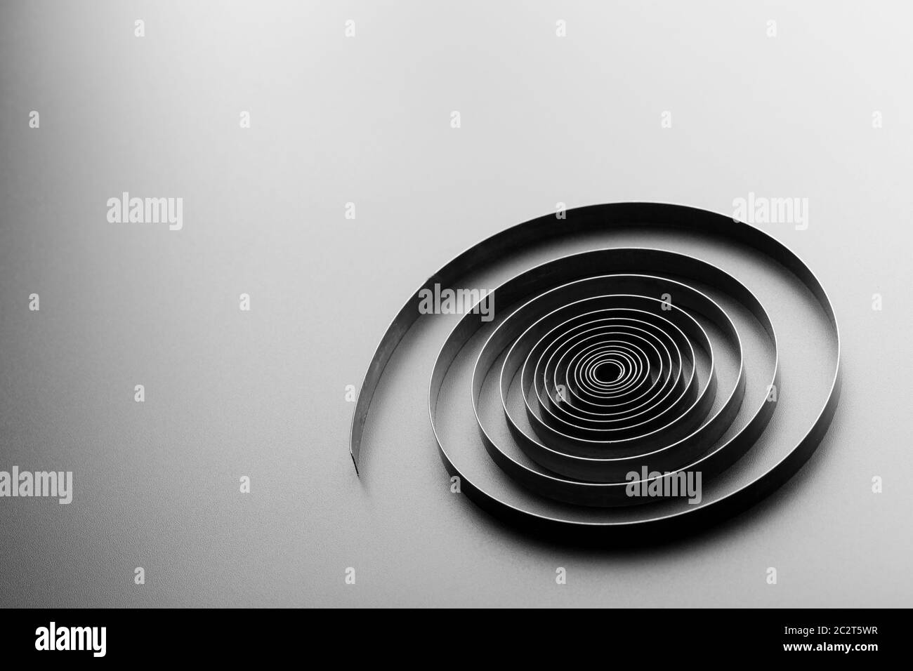 Abstract metallic spiral on grey background Stock Photo