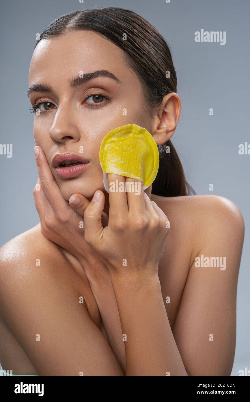 Beautiful female doing face cleansing with washcloth Stock Photo Alamy