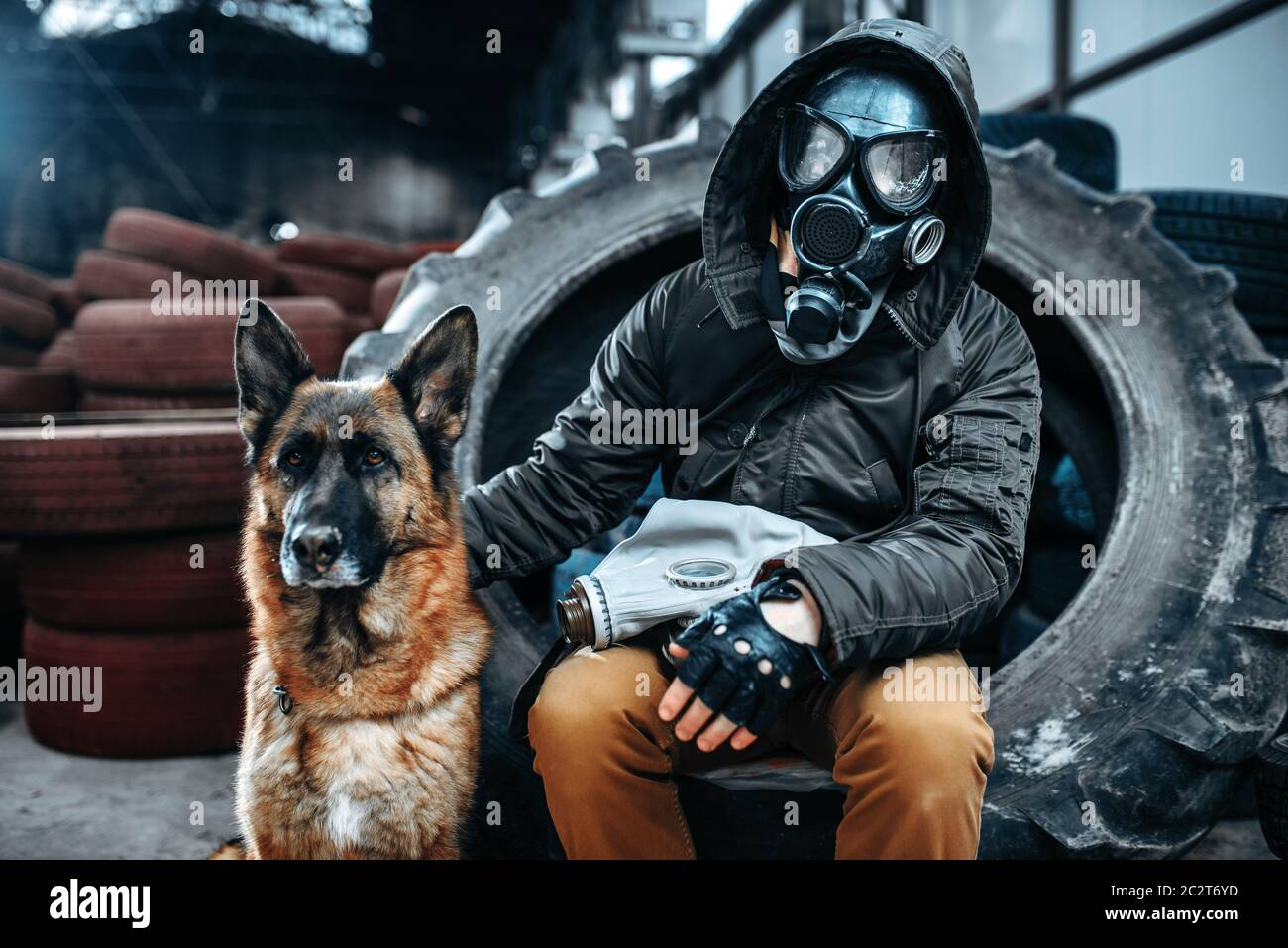 Stalker in gas mask and dog, friends in post apocalyptic world. Post-apocalypse lifestyle on ruins, doomsday, judgment day Stock Photo
