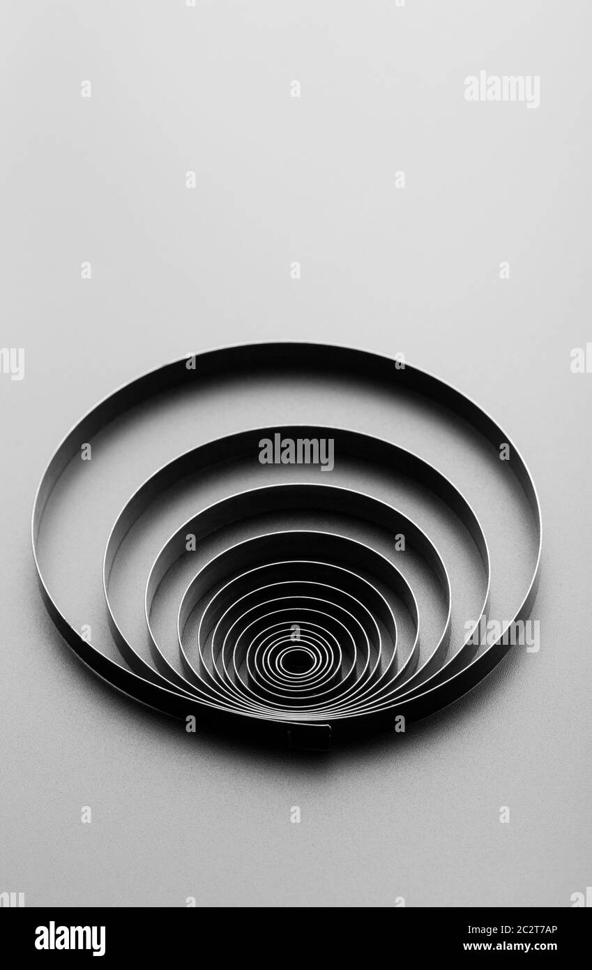 Abstract metallic spring on grey Stock Photo - Alamy
